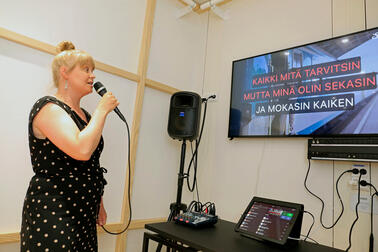 A woman sings karaoke.