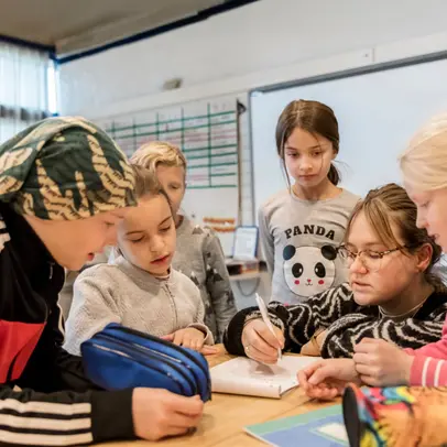 Children in class with teacher.