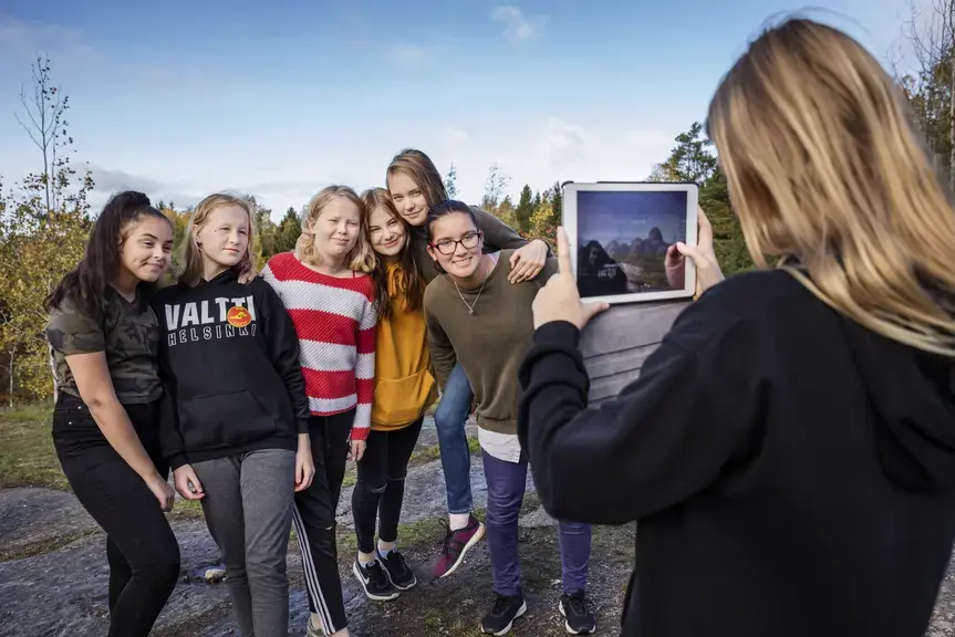Pupil takes a photo or peers