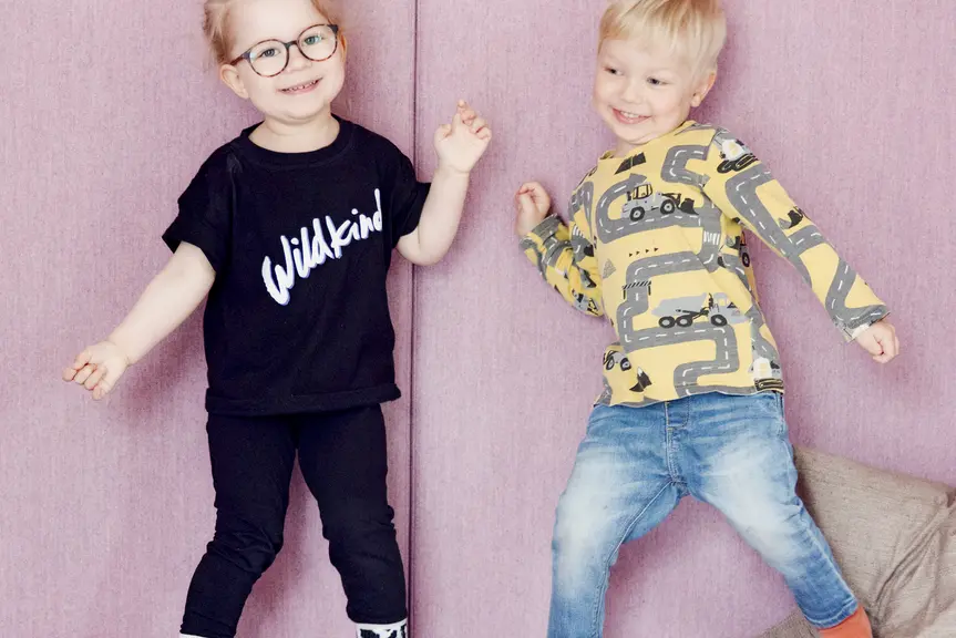 Two children dancing and smiling.