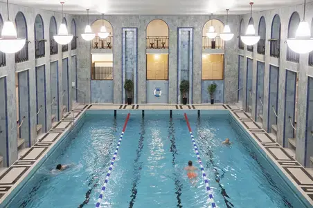 Swimming pool and three swimmers.