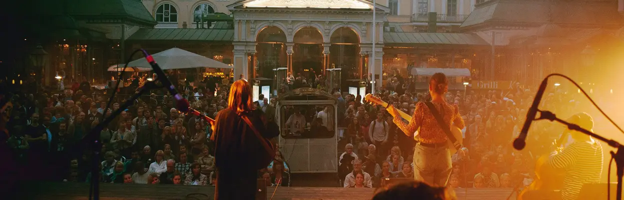 The music band plays on Espa's stage and there is a lot of audience in front of the performance stage.