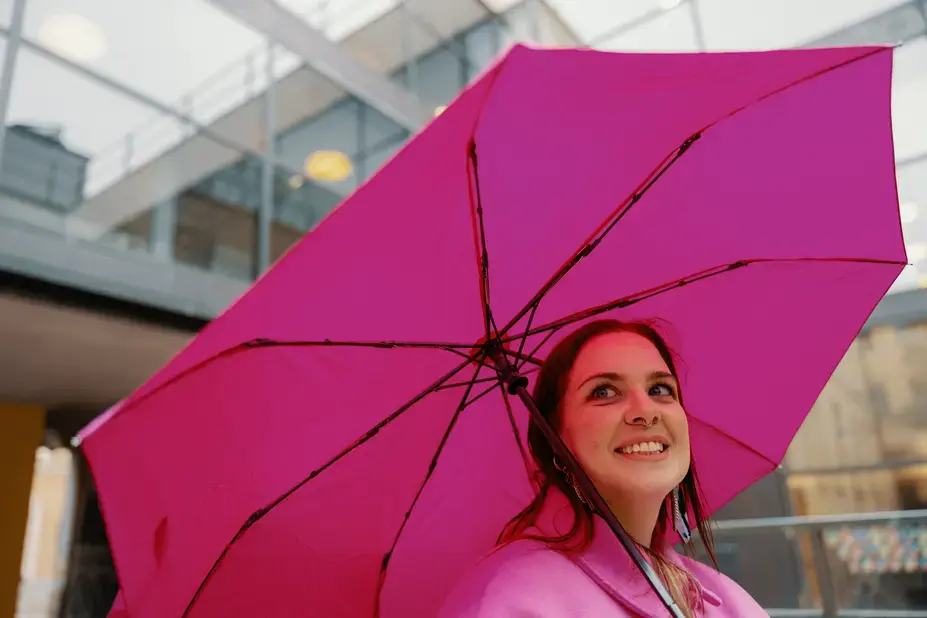 Woman holding pink umbrella